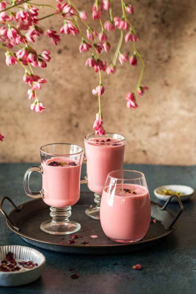 Strawberry rose lassi served in 3 glasses.