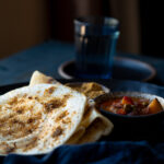 This is a picture of podi dosa (gun powder dosa) served on a plate.