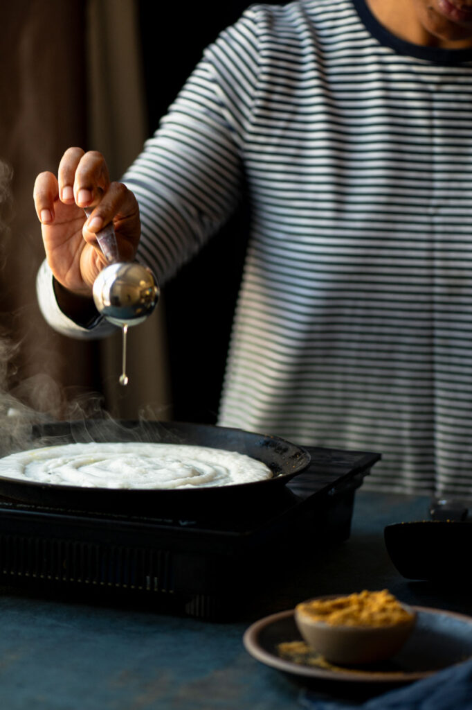 Pour oil/ghee around the edges to make podi dosa.