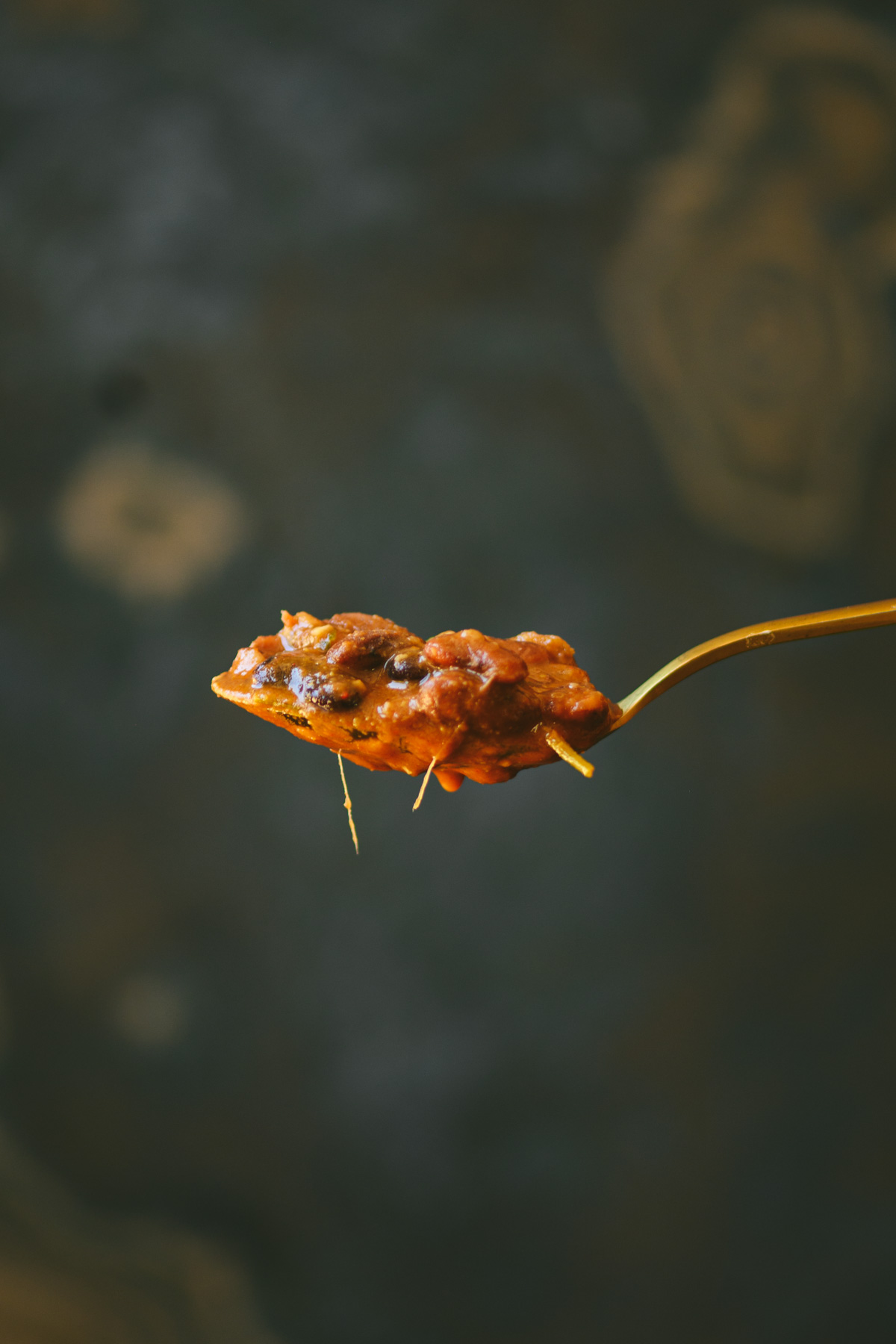 This is a picture of Rajma masala on a spoon.