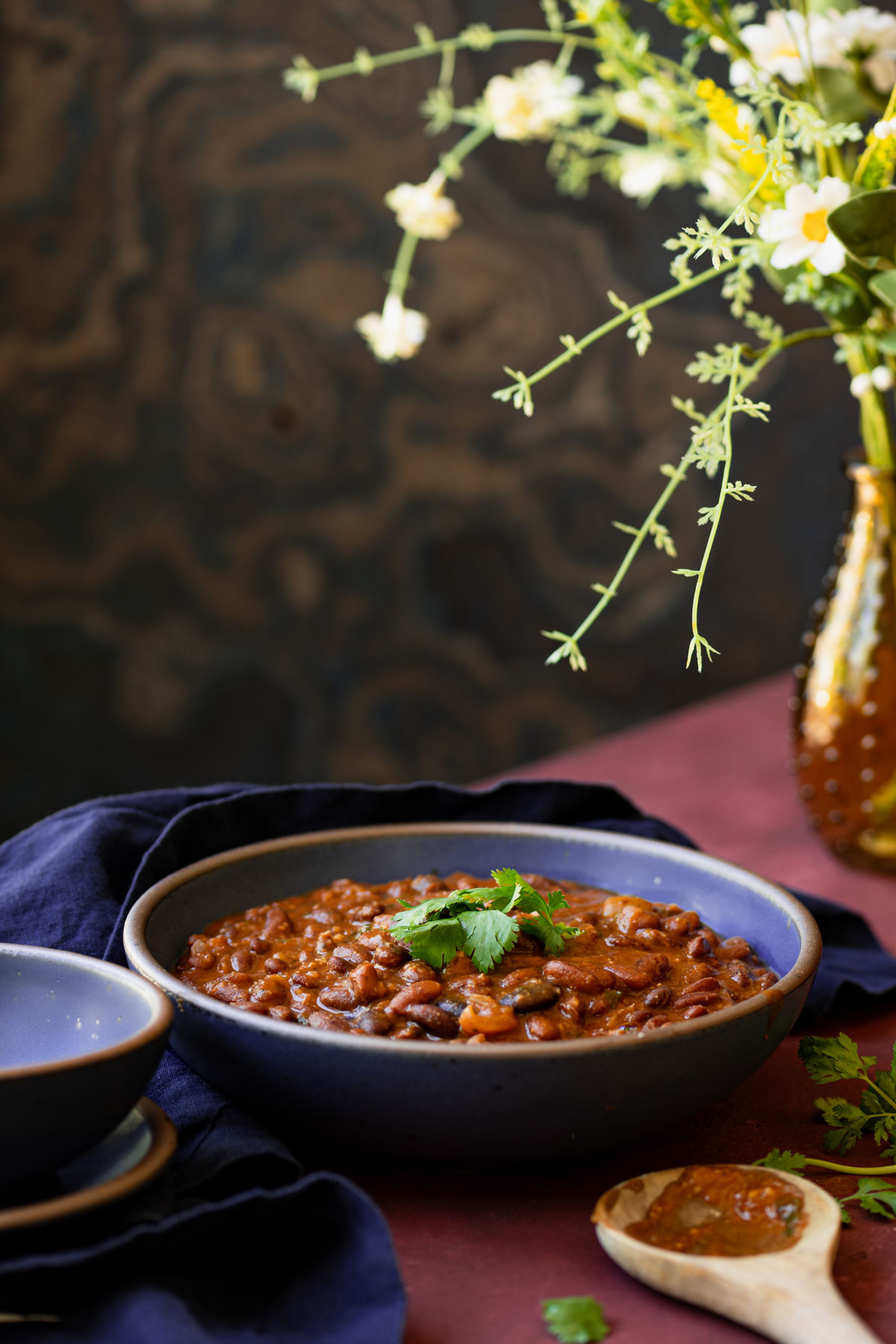 Punjabi rajma served on a blue bowl on a table.