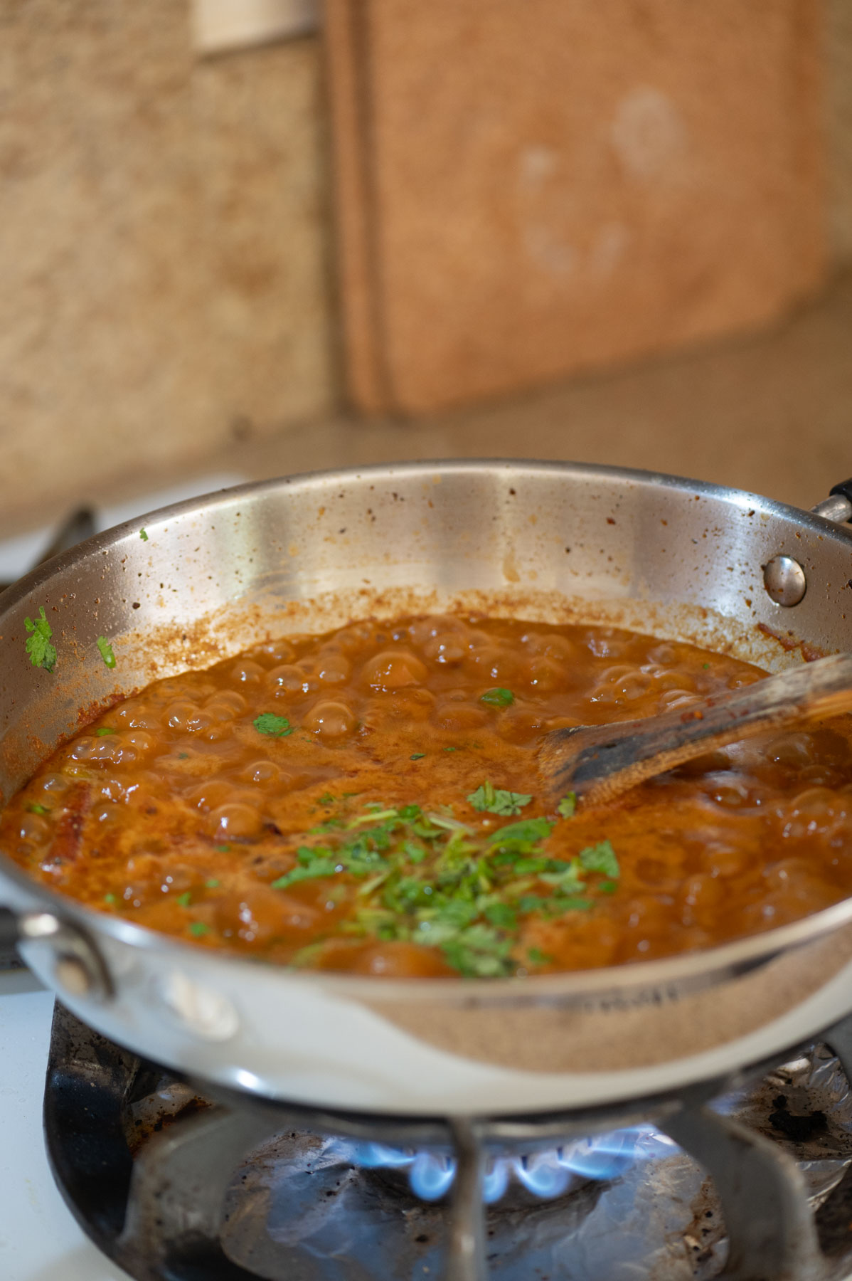 Adding cilantro the the rajma masala