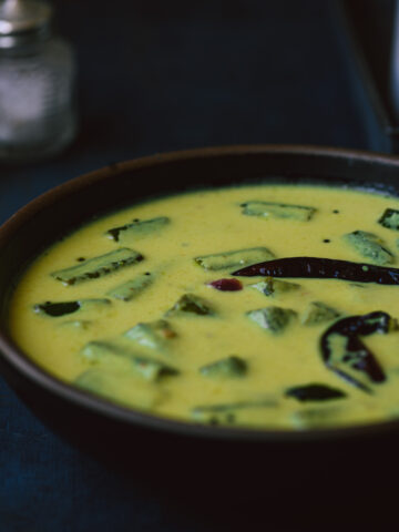 Vendakkai mor kuzhambu served in a blue bowl.