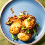 Muttai thokku with 3 hard boiled eggs on a serving plate.