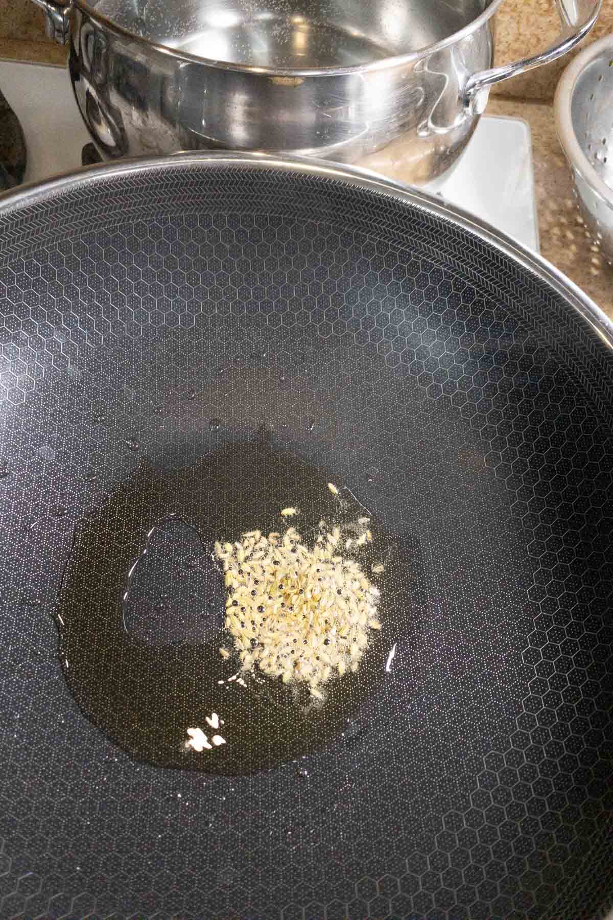 Add fennel seeds to the hot oil to make muttai thokku.