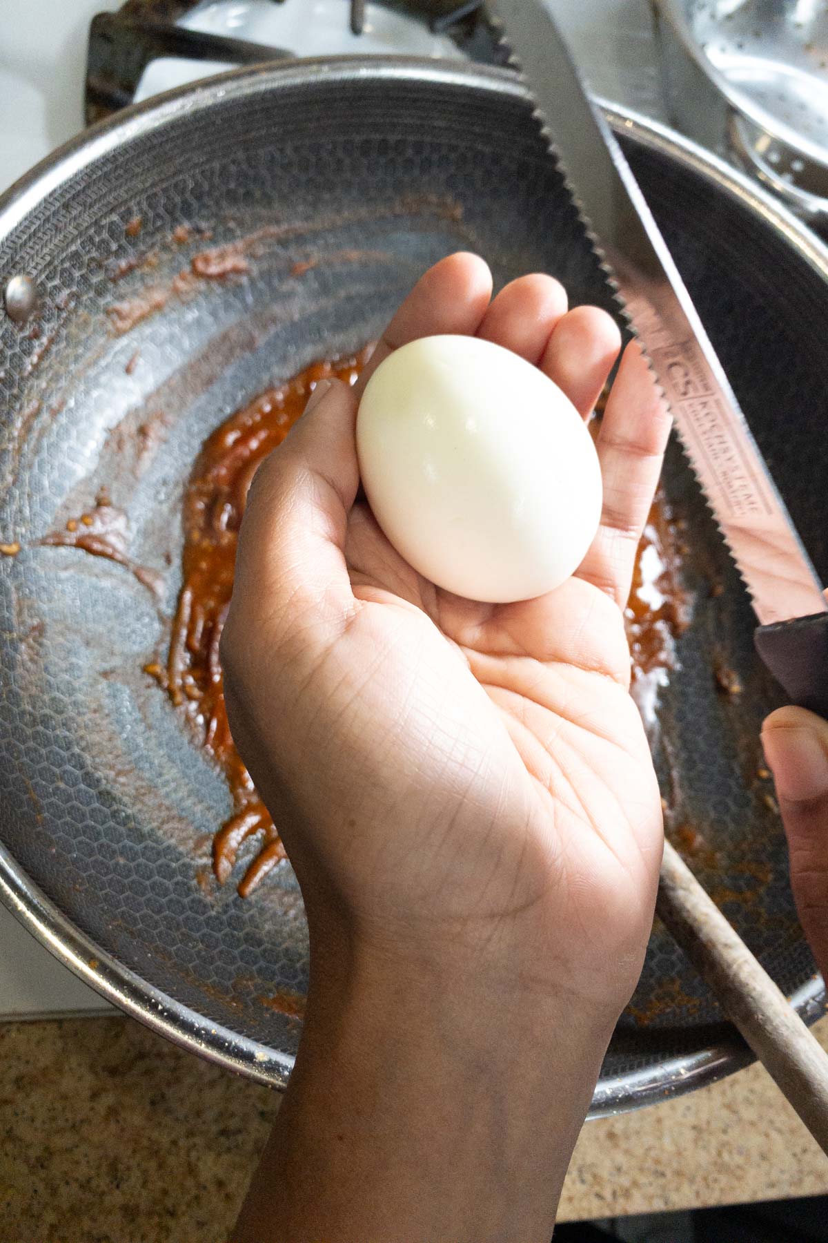 Score the eggs along the sides before adding to the thokku masala.