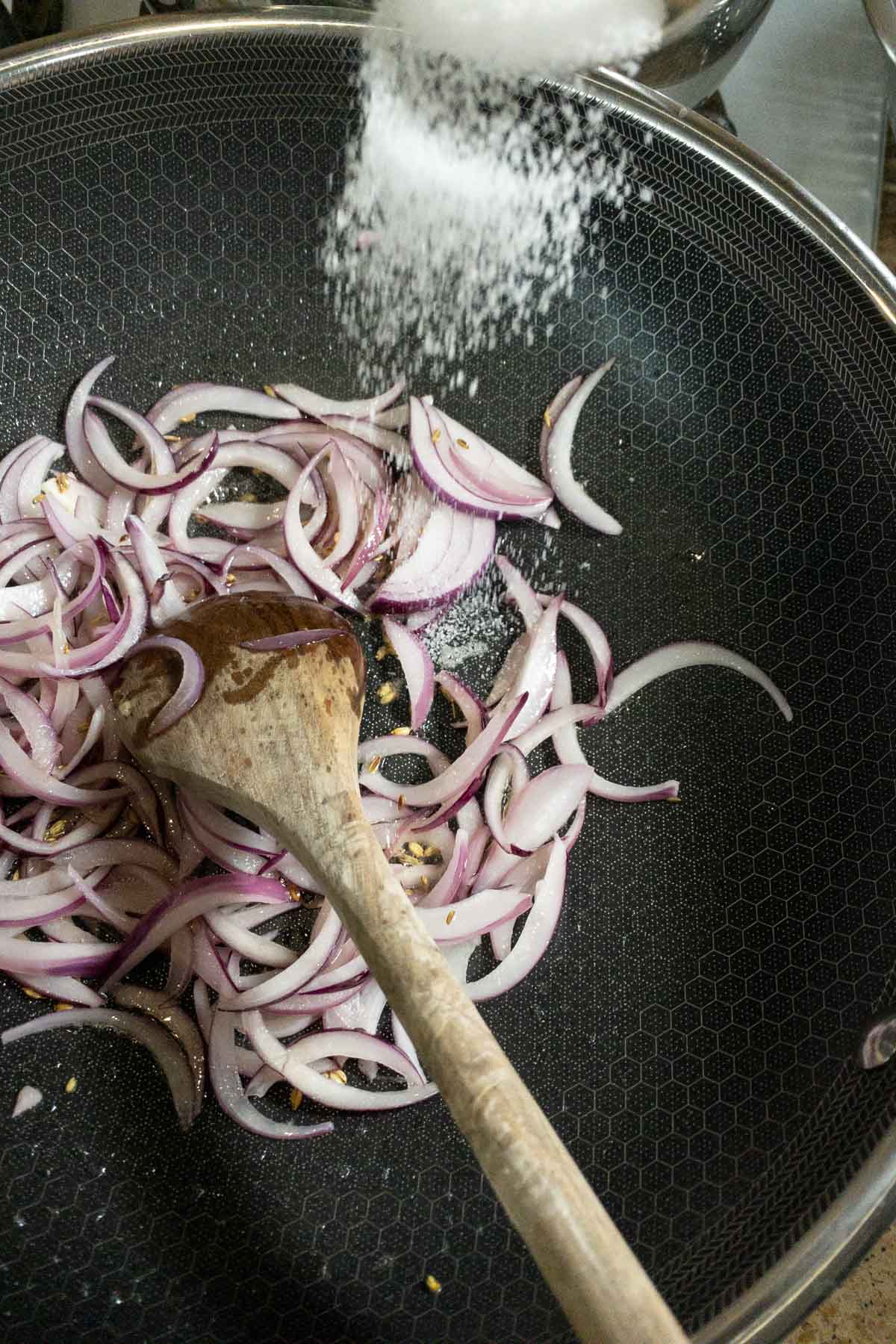 Sauteing until the onions turn soft and translucent.