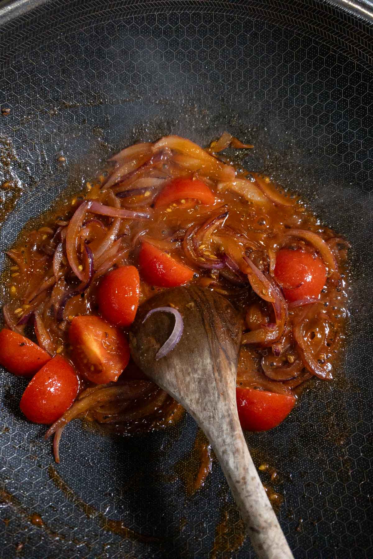 Add sliced fresh tomatoes to the pan.