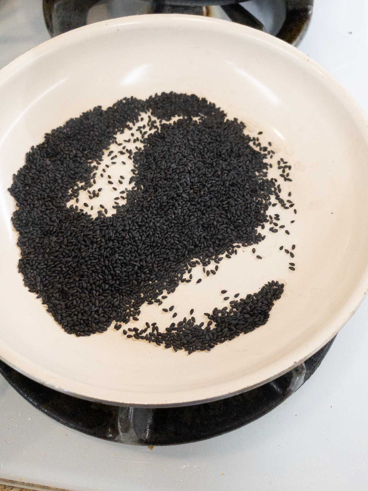 Dr roast the sesame seeds until they crackle and sputter.