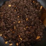 Combine steamed ragi flour with the peanuts and roast well.