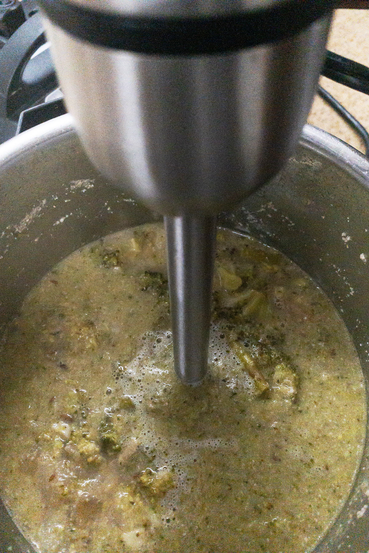 Blend the ingredients for almond broccoli asparagus soup.