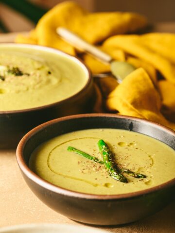 This is a picture of Almond Broccoli Asparagus soup served on a bowl.