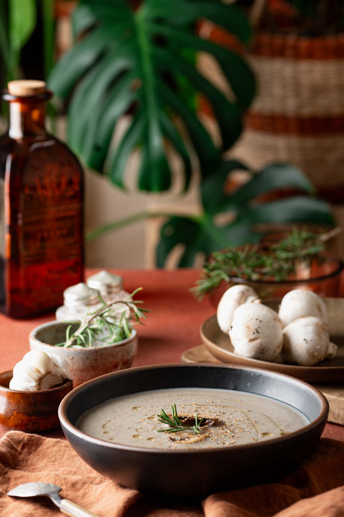 Dairy free cream of mushroom soup in a bowl along with a napkin and spoon.