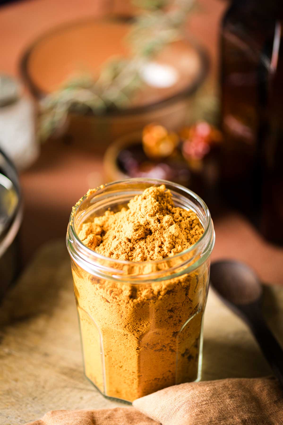 This is a picture of vatha kuzhambu podi in a storage jar.