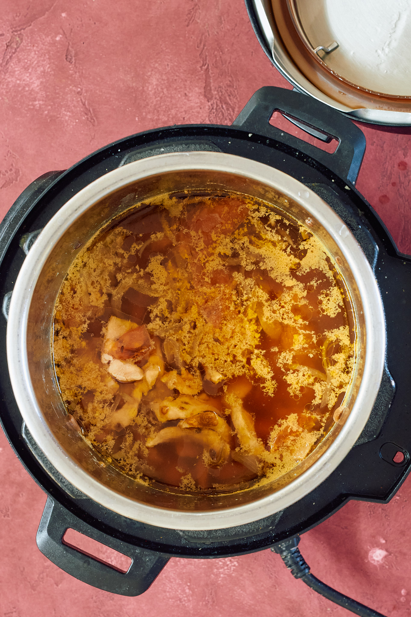 This is a picture of the cooked indian chicken soup after opening the lid.