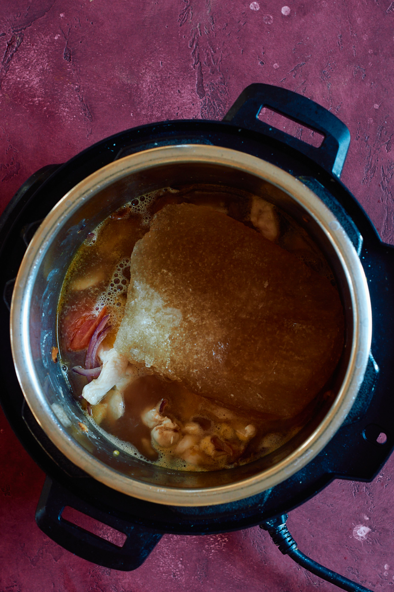 Adding the chicken broth to the instant pot.