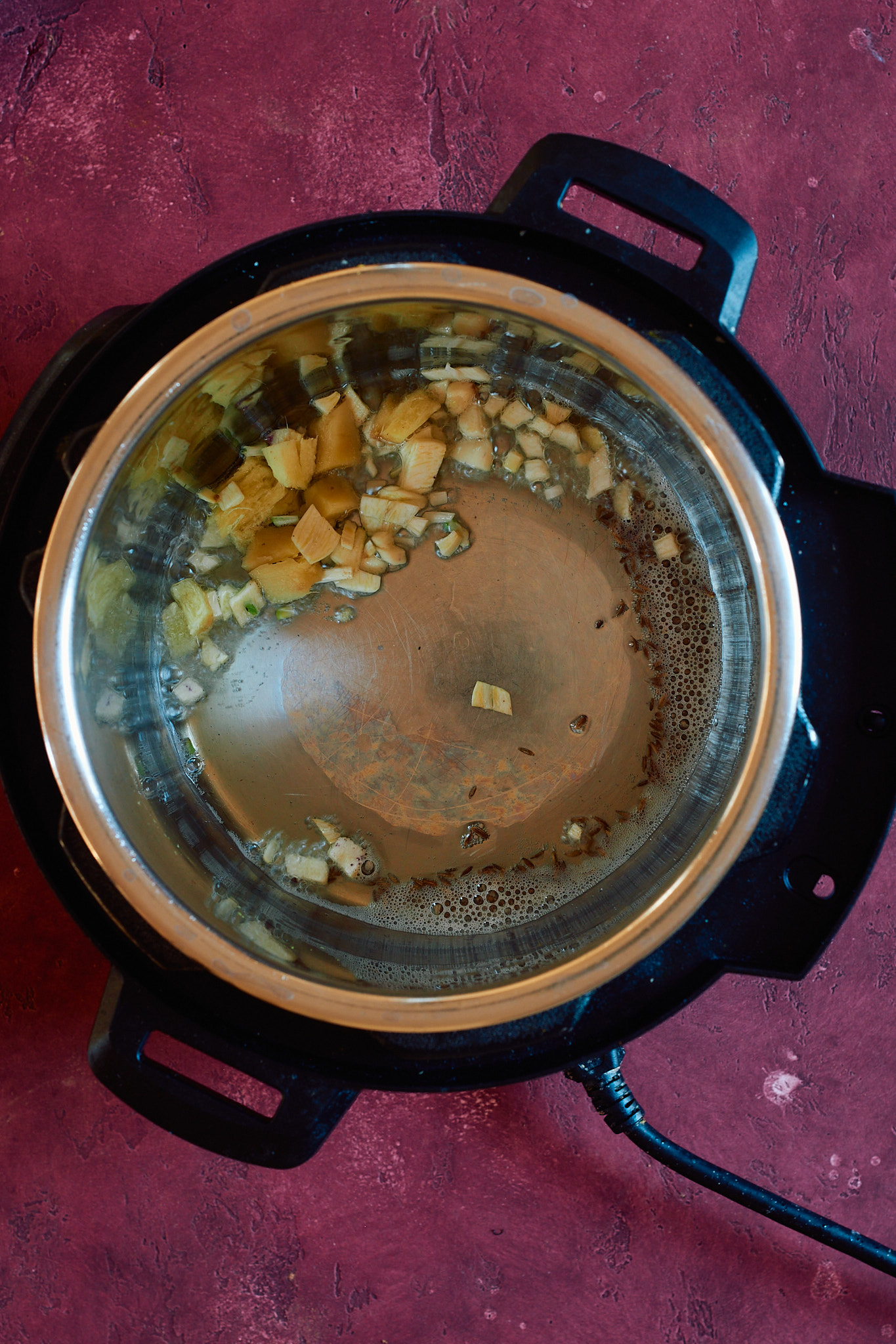 Added cumin seeds, garlic, ginger to the instant pot on saute mode.